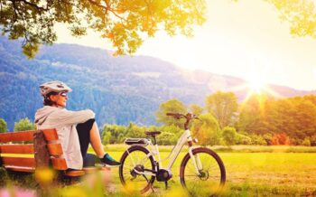 woman relaxing beside her e-bike - e-power 05 woman relaxing beside her e-bike - e-power 05